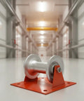 Heavy Duty Cable Guide Wheel With Ground Mount Steel Support Bracket And Slick Aluminum Pulley Roller on red base, close-up in workspace.