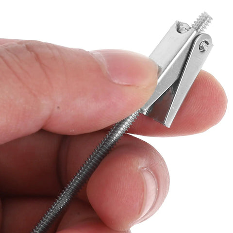 Hand holding a piece of Heavy Duty Toggle Bolts And Wing Nut Kit 15 Sets Carbon Steel Wall Anchors For Drywall And Hollow Bricks Pro Grade Hardware