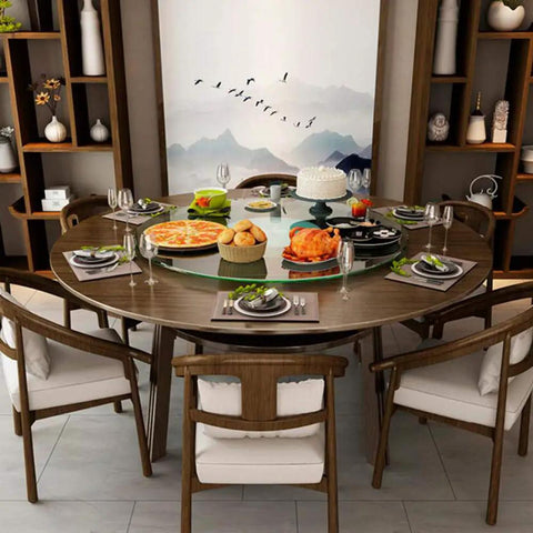 Kickass Heavy Duty Lazy Susan Turntable With Thick Tempered Glass Top and Stainless Steel Bearings on a dining table filled with food.