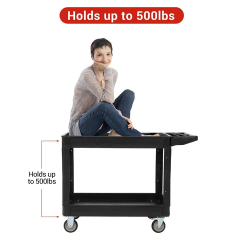 Rock Solid Heavy Duty Two Shelf Foldable Utility Cart With 500 Pound Capacity And Smooth Rolling Casters That Glide Like A Dream For Garage Warehouse Tool Storage Jobs with a person sitting on it