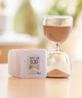 Portable Home Radon Detector With 10 Minute Readings beside hourglass on table