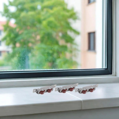 Four Piece Sliding Door Rollers With Double Wheel Bearing Track Pulleys For Smooth As Butter Glide, stainless steel rollers on windowsill.