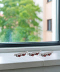 Heavy Duty Stainless Steel Sliding Window Roller Set Featuring Dual Wheels, installed on a window sill for smooth operation.
