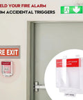 Straight Up Tough Fire Alarm Pull Station Cover next to a fire exit door for protection against accidental triggers.