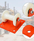 Heavy Duty Cable Guide Wheel With Ground Mount Steel Support Bracket And Slick Aluminum Pulley Roller close-up showing aluminum roller and red base.