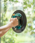 Hand gripping Heavy Duty 9 Inch Vacuum Concave Suction Cup for Granite and Glass Lifting on glass surface.