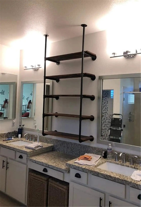 Industrial Pipe Shelf Kit With Wall Mount Brackets And Five Tier Open Shelves In Black Matte 68 Inches Tall 10 Inch Deep Hardware Only No Wood Planks DIY Vintage Industrial Storage For Office Kitchen And Living Space installed above twin sinks in a bathroom.