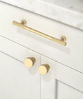 Pro Grade Brushed Gold Cabinet Pulls And Drawer Handles 5 Inch Center To Center kitchen hardware installed on white cabinets.