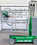 2016 Compact Self Propelled Electric Vertical Mast Lift Featuring Slick Drivability At Full Height Smooth Handling Verified Low Hours And Rock Solid Build Quality Ready To Crush Any Job Site Task side view of Genie GR-20 vertical lift in warehouse setup.