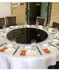 Smooth As Butter Lazy Susan Turntable For Dining Table on a set dining table with glasses and plates, ready for meals.
