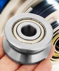 Top Shelf Heavy Duty V Groove Track Roller Sealed Ball Bearing Lv201zz Precision Ground Workhorse for Industrial use in hand.