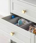 Kickass 10 Pack Gold Knurled Cabinet Knobs With Brushed Gold Finish Heavy Duty Drawer Pulls For Kitchen Cabinets And Dressers on a drawer storing baby items.