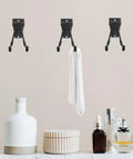 Rock Solid Black Metal Wall Hooks For Bags And Hats With Heavy Duty Mount holding a towel, ideal for bathroom or garage organization.