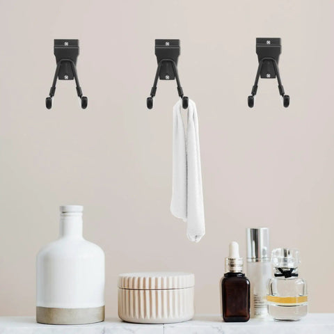 Rock Solid Black Metal Wall Hooks For Bags And Hats With Heavy Duty Mount holding a towel, ideal for bathroom or garage organization.