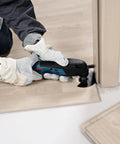 Person using 12V Max EC Brushless Starlock Oscillating Multi Tool Bare Tool with 3-D Starlock Interface for flush cut in wood panel