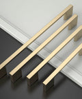 Top Tier Ten Inch Brushed Brass Cabinet Handles And Sturdy Long Drawer Pulls 10 Pack on a white surface.
