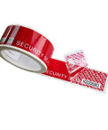 Tamper-evident red security tape roll with white “SECURITY SEAL” text, partially unrolled with a serial-number label.