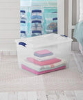 Six Pack Of 66 Quart Clear Plastic Storage Containers With Sleek Blue Latching Lids Designed For Heavy Duty Stackable Organization And Hassle Free Clutter Control In Your Living Room Or Home Office, filled with folded blankets.