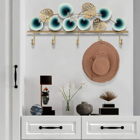 Slick Leaf Design Wall Mounted Coat Rack For Entryway Door with heavy duty hooks, displaying a hat and decorative items.