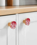 Killer Red Abstract Painted Wooden Cabinet Knobs 2 Piece Set 1.4 Inch Round Drawer Pulls For Kitchen Cabinets displayed on bright drawers.