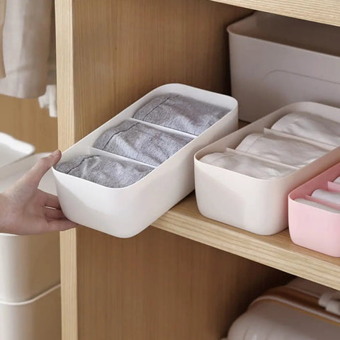 Four Piece Plastic Drawer Organizer Box With Compartment Dividers For Bras Underwear And Socks Nifty Closet Storage Bins in a drawer.