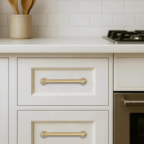 Top Shelf 10 Pack Brushed Brass Cabinet Pulls 5 Inch centered on white drawer in a modern kitchen setting.
