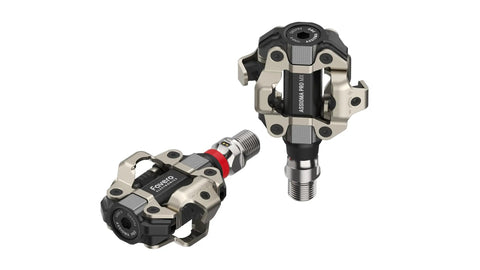 Assioma Pro MX1 Upgraded Single Sided Power Meter Pedals Bundle with extra SPD cleats and multi-tool, showing aluminum pedals