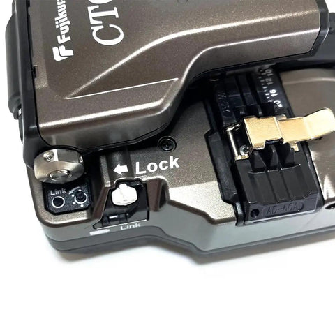 Pro Grade Optical Fiber Cleaver Featuring Motorized Blade And Automatic Rotation Bluetooth Sync showing top view with lock and link buttons.