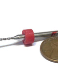 1.1mm micro drill bit with pink holder, shown next to a penny for scale, ideal for PCB maintenance and CNC projects.