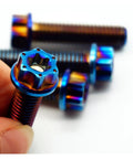Top Shelf Grade 5 M8 Titanium Screws 4 Pack Burning Blue Torx Flange Head Bolts in hand, showcasing burnished blue finish.