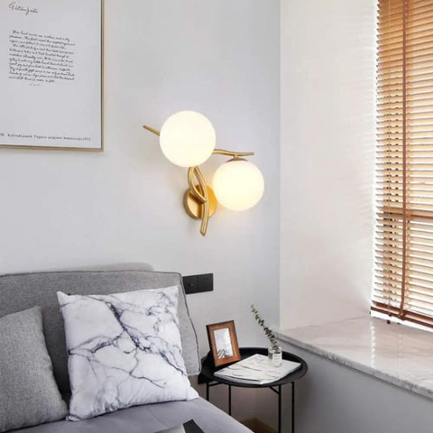 Retro Industrial Double Head Wall Sconce With Brushed Gold Accents And Crisp White Glass illuminating a cozy bedside setup.