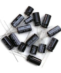 Ultimate Capacitor Replacement Kit For Xbox V1.0 Motherboard With Lead Free Solder Wire And Wick High Temperature Caps, various capacitors arranged.