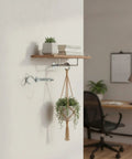 Installed hollow wall mounting kit with toggle bolts holding a wooden shelf and plant, heavy duty metal anchor set in silver, no studs required.