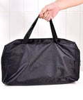 Carrying bag for Ultra Lightweight Portable Folding Camping Grill With Handy BBQ Tool Set, shown with hand holding straps.