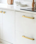 Top Shelf Gold Plated Solid Brass Cabinet Pulls Heavy Duty Drawer Handles on white kitchen cabinets, 220 Millimeter size.