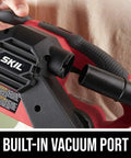 Hand holding Beast 6 Amp Belt Sander with built-in vacuum port, showcasing micro filtration dust system for smooth wood finishes.