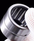 Top Shelf Machined Needle Roller Bearing Set With Heavy Duty Outer Ring Flanges And Tight Guided Cages For Slick Shaft Mounting, showing caged needle rollers.