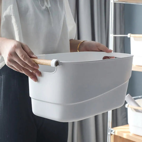 Person holding a Top Shelf White Plastic Storage Basket With Lidless Opening For Zero Fuss Organization And Straight Up Space Saving Efficiency.
