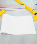Self Adhesive Wallpaper For Kitchen Backsplash With Clear Removable Wall Protector rolled on a wooden surface with tools.