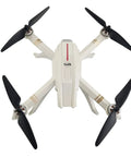 Quadcopter top view with black blades, part of 16 Piece Drone Propeller Set For Brushless Quadcopters Replacement Blades