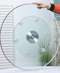 Heavy Duty Tempered Glass Lazy Susan Turntable With Large Rotating Serving Tray held by hand showcasing smooth design and anti-collision edge.