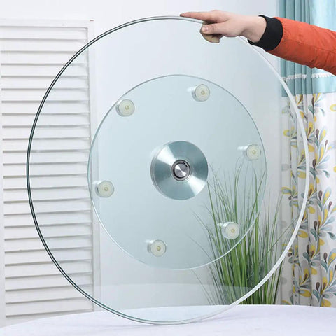 Heavy Duty Tempered Glass Lazy Susan Turntable With Large Rotating Serving Tray held by hand showcasing smooth design and anti-collision edge.