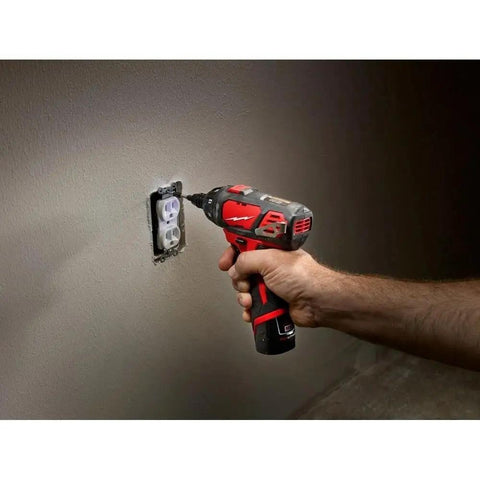 Person using Compact Cordless Driver Drill Kit Featuring Variable Speed Trigger And Quick Change Chuck on wall socket.
