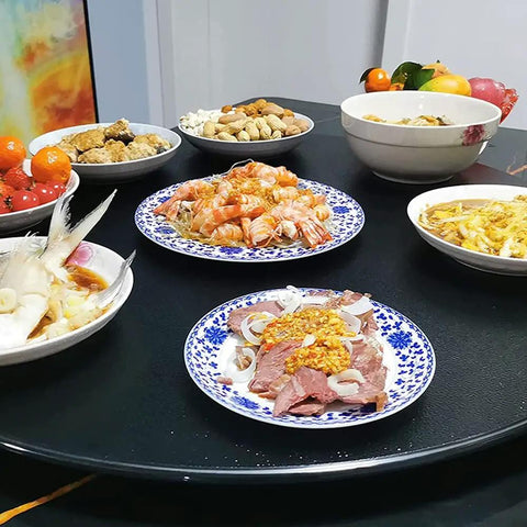 39 Inch Black Tempered Glass Lazy Susan Turntable Featuring A Smooth Glide 360 Spin For No Fuss Kitchen Serving, loaded with seafood and dishes.