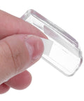 Close-up of hand applying adhesive on 4 Pack Transparent PVC Table Corner Protectors, nearly invisible edge guards.