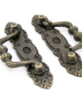 Two vintage antique brass bail pulls for drawers with distressed finish, part of Six Pack Vintage Antique Brass Bail Pulls For Drawers Cabinets Dressers Cupboards Set Featuring 4.1 Inch Length And 1.5 Inch Height Inter Hole Spacing 3.5 Inches Made From Zinc Alloy With Distressed Finish Retro Rustic Hardware set.