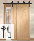Heavy Duty Sliding Barn Door Hardware Kit Double Track System With Smooth Ride Rollers And Drop Dead Simple Install Bent Hangers In Slick Black Finish installed above two wooden doors.