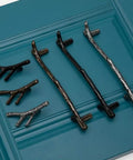 2 Pack Black Twig Branch Knobs Zinc Alloy Cabinet Handles Rust Resistant Furniture Pulls Nailed Design Wardrobe Door Knobs Smooth Texture Decorative Drawer Hardware displayed on blue background.