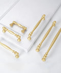 10 Pack 5 Inch Brushed Gold Cabinet Pulls Heavy Duty Zinc Alloy Drawer Handles For Kitchen Cupboards And Dressers laid out on a white surface.