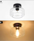 Industrial Semi Flush Mount Ceiling Light With Clear Glass Pendant Shade Farmhouse Vibe For Hallways And Living Areas Vintage Yet Modern Hanging Fixture With Black Matte Finish, shown on and off